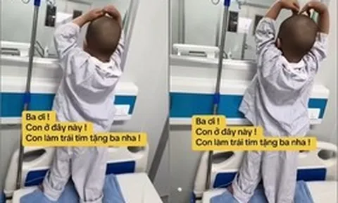 Nhói lòng với clip chiến binh ung thư nhí kiễng chân nhún nhảy gửi trái tim qua ô cửa kính như động viên bố: Ba ơi, đừng sợ!